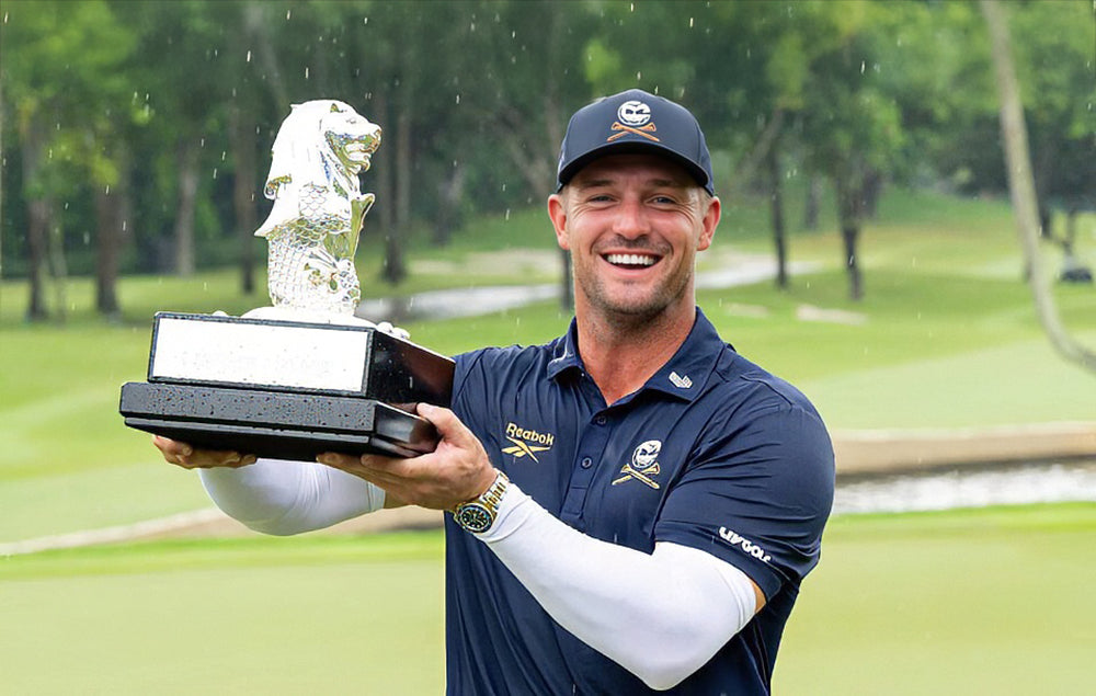 Bryson DeChambeau holding LIV Singapore trophy